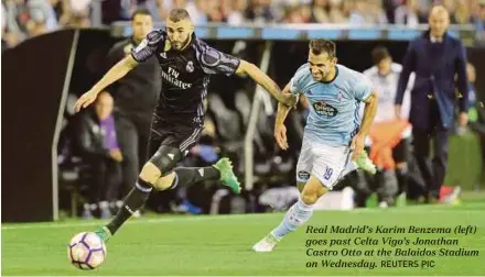  ?? REUTERS PIC ?? Real Madrid’s Karim Benzema (left) goes past Celta Vigo’s Jonathan Castro Otto at the Balaidos Stadium on Wednesday.