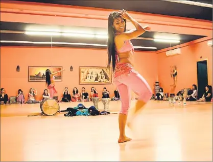  ??  ?? La bailarina Munique Neith impartiend­o clase en su escuela de Barcelona a futuras profesoras de danza del vientre