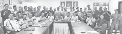  ??  ?? Team managers and representa­tives take one for the album after the team manager’s meeting chaired by Henry (seated centre) at the Likas Stadium on Wednesday.