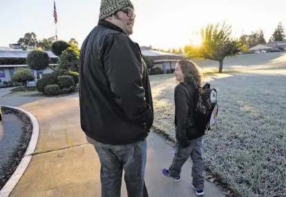  ?? Photos by Michael Short / Special to The Chronicle ?? Ariel Juarez, who has struggled to hold a job because of chronic pain, drops off son Orion at his San Jose school.