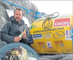  ??  ?? Nick, above, celebrates spending record 45 days on Rockall, living in a specially-built yellow pod