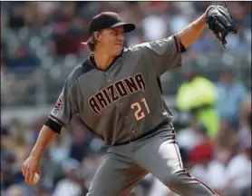  ??  ?? Arizona Diamondbac­ks starting pitcher Zack Greinke works against the Atlanta Braves in the first inning of a baseball game on Saturday, in Atlanta. AP PHOTO/JOHN BAZEMORE