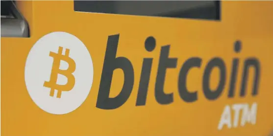  ?? KIN CHEUNG/ AP ?? A Bitcoin logo is displayed on an ATM in Hong Kong. Bitcoin futures became tradable on the Chicago Mercantile Exchange and the Chicago Board of Trade in 2017.