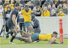  ??  ?? Australia’s Israel Folau scores a try against Argentina.