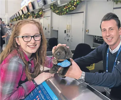  ??  ?? A GIRL has been reunited with the cuddly toy she lost at an airport after images of it were shared around the world.
Eve Mcilquham, 10, was distraught when she lost her chocolate Labrador toy Basil on a trip with mum Lorraine to Canada in July.
Basil...