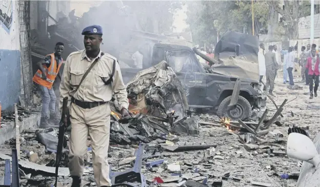  ?? PICTURE: AP ?? 0 A Somali soldier among the wreckage outside the Nasa-hablod hotel in Mogadishu after a terror attacker that left 23 dead