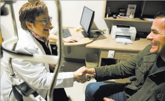  ?? Erik Verduzco ?? Las Vegas Review-journal Dr. Carolyn Cruvant talks with patient Christophe­r Mcgill at Shepherd Eye Center. Cruvant received eye care at the center before she became an employee there.