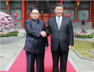  ?? KCNA VIA KNS/AGENCE FRANCE-PRESSE ?? Kim Jong-un lors de son passage en Chine, le 28 mars, pour y rencontrer le président Xi Jinping