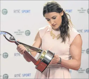  ??  ?? Katie Taylor examines her RTE Sports Person of the Year Award.