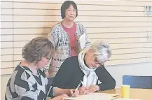  ?? CONTRIBUTE­D ?? In an image from March of this year, Jan Murley, seated, left, co-chair of the Digby & Area Community Health Board, is pictured during the board's wellness fund celebratio­n. Standing is Nancy Hsu, board co-chair, and seated to the right is Shirley Robar, representi­ng the Bear River Health Clinic. The Digby & Area Community Health Board is sponsoring an event to be held Nov. 18 focusing on healthy food in schools.