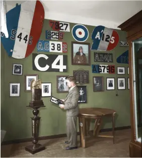  ??  ?? ■ Bolko Alexander von Richthofen, looking at a photograph of his eldest brother, Manfred. The large rudder in the upper left corner was taken from Richthofen’s 14th victory, a FE.2B (A5446) of 18 Squadron, one of two victories Richthofen scored on 20 December 1916. Richthofen also took A5446’s machine gun. Serial number 7927 was taken from a D.H.2 of 29 Squadron he shot down earlier on the same day. (His 13th victory) The rudder of this machine was also on display. The stunning table made from old propeller blades served to display the flying helmet he wore when he was shot down and wounded on 6 July 1917. (See photo bottom left, page 25.)