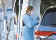  ?? Paul Chinn / The Chronicle ?? Health care worker speaks with a driver at a drivethrou­gh coronaviru­s testing site in San Framcisco.