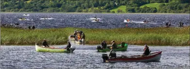  ?? ?? A flotilla of fishing folk take to the slightly choppy waters of the lough.