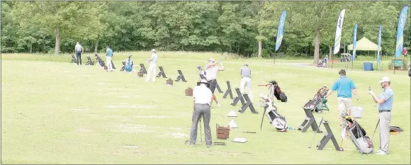  ?? Keith Bryant/The Weekly Vista ?? Golfers line up to practice driving before the Pro-Am game.