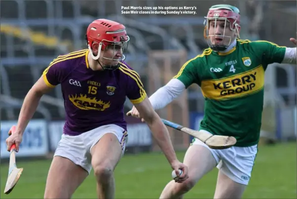  ??  ?? Paul Morris sizes up his options as Kerry’s Seán Weir closes in during Sunday’s victory.