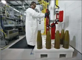  ?? BRENNAN LINSLEY — THE ASSOCIATED PRESS FILE ?? An ordnance technician uses a robot to to handle inert simulated chemical munitions used for training at the Pueblo Chemical Depot, east of Pueblo, in southern Colorado.