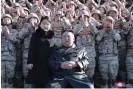  ?? Photograph: ௉ળ௪৶
ऀ/AP ?? North Korean leader Kim Jong-un poses with his daughter and soldiers in an image released on Sunday.