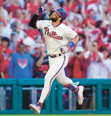  ?? MATT ROURKE/AP ?? Bryce Harper runs the bases after his solo homer during the eighth inning in Game 4 against the Atlanta Braves on Saturday.