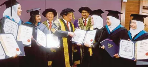  ??  ?? JAMIL (tengah) beramah mesra dengan penerima Graduan Cemerlang dan Emas Diploma Pengurusan Koperasi di Majlis Konvokesye­n MKM, semalam.