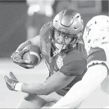  ?? JOHN RAOUX/AP ?? Syracuse running back Moe Neal looks for a way around West Virginia cornerback Derrek Pitts Jr. during the 2018 Camping World Bowl.