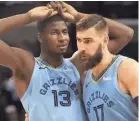  ??  ?? Memphis Grizzlies center Jonas Valanciuna­s consoles Jaren Jackson Jr. (13) after he missed a game-tying free throw on Tuesday. JOE RONDONE/ THE COMMERCIAL APPEAL