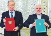  ?? AP ?? Zarif and Lavrov, pose after the ceremony of signing documents in Tehran yesterday. Lavrov said Moscow expected the Iranian nuclear deal to be saved and condemned EU sanctions against Iran, saying they could undermine sensitive talks.