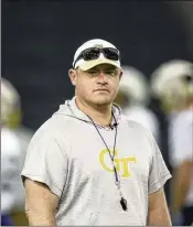  ?? JASON GETZ/JASON.GETZ@AJC.COM ?? Georgia Tech head coach Brent Key watches warm-ups during their first day of spring football practice at the Brock Indoor Practice Facility March 11 in Atlanta.