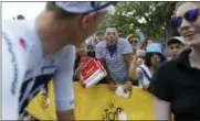  ?? CHRISTOPHE ENA — THE ASSOCIATED PRESS ?? A man, center, expresses his disapprova­l of Britain’s Chris Froome, left, by booing prior to the start of the fifteenth stage of the Tour de France cycling race over 181.5 kilometers (112.8miles) with start in Millau and finish in Carcassonn­e, France, France, Sunday. Froome was cleared of doping by the Internatio­nal Cycling Union in a decision that will allow him to pursue a record-tying fifth Tour de France