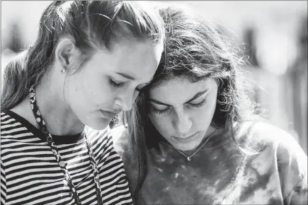  ?? PAUL MARTINEZ / THE NEW YORK TIMES ?? Students attend a prayer service Thursday at Parkridge Church in Coral Springs, Fla., a day after a mass shooting occurred at the nearby Marjory Stoneman Douglas High School. Seventeen people were killed and at least 14 others were injured in the...