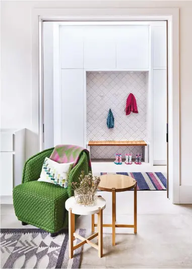  ??  ?? Colour and texture dot the home. Quilted ceramic tile by Black Rock Studio and a custom walnut bench with a “tufted” seat define the mud room. Runner from Y&amp;CO.; chair from Klaus; rug by Studio Euewes; vase from Mjölk.