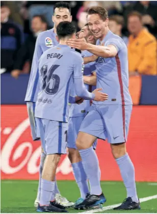  ?? GETTY IMAGES ?? Late charge: Luuk de Jong of FC Barcelona (right) celebrates after scoring his side's third goal during the La Liga match against Levante in Valencia, Spain.