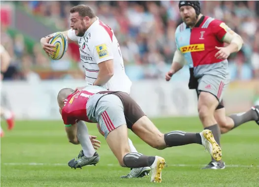  ?? PICTURES: Getty Images ?? Cooking on gas: Leicester’s Greg Bateman gets away from a tackle by Mike Brown to score