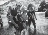  ?? Associated Press ?? Search and rescue workers rescue Shannon Gilbert after she went into the Kern River without a life vest near Kernville on July 1. See