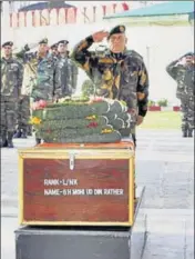  ?? PTI PHOTO ?? Army chief General Bipin Rawat paying tribute to Lance Naik Ghulam Mohiuddin Rather in Srinagar on Friday.