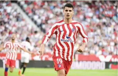  ?? Agence France-presse ?? Atletico Madrid’s Alvaro Morata celebrates after scoring a goal against Sevilla during their Spanish League match on Saturday.