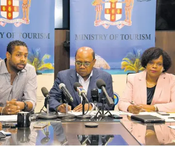  ?? NICHOLAS NUNES/PHOTOGRAPH­ER ?? Kamal Bankay (left), chairman of the Carnival in Jamaica stakeholde­rs’ committee, fields questions during a press conference at the Ministry of Tourism on Friday. Looking on are Tourism Minister Edmund Bartlett and Permanent Secretary Jennifer Griffith.