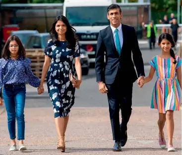  ?? @RISHISUNAK­MP/INSTA ?? FAMILY MAN Sunak with wife Akshata and daughters Anoushka and Krishna