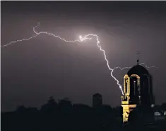  ??  ?? Strike action: lightning flashes through the night sky over south London