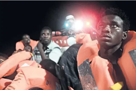  ??  ?? Some of the migrants are rescued earlier by the Aquarius, which has been refused entry to Italian and Maltese ports but has been invited to dock in Valencia – three days’ travel away