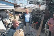  ?? Evan Vucci, The Associated Press ?? President Donald Trump visits a New Bern, N.C., house Wednesday where a boat washed into the backyard during Hurricane Florence.