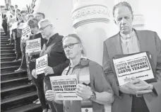  ?? JAY JANNER, AUSTIN AMERICAN-STATESMAN, VIA AP ?? Members of the clergy pray outside the House chamber in Austin in opposition to bills they consider anti-LGBT.