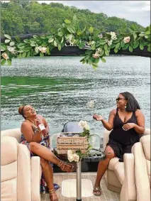  ?? CONTRIBUTE­D. ?? Candis Harris, (left) and Daniele Mays took a mid-July boat ride on Lake Lanier. Mays is an event coordinato­r and said the COVID-19 pandemic has forced her to plan outdoor only events. Though she and Harris took their masks off for this picture, Mays said she and the other eight people onboard wore them most of the time for the party.