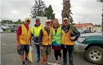  ?? SUPPLIED ?? Members from the Tuakau Lions Club working together with Jacqui Church at the recent Tuakau Clean Up and Planting Group event.