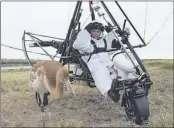  ?? ALEXEI DRUZHININ, PRESIDENTI­AL PRESS SERVICE /ASSOCIATED PRESS ?? In his latest action-man stunt, Russian President Vladimir Putin led young cranes on a migratory lesson in an ultralight plane. He’s dressed like an adult crane.