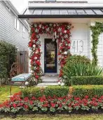  ??  ?? More than 300 bulbs in red, black and white hang on a garland around Gust’s front door. Red cyclamen in the yard offer complement­ary holiday color.