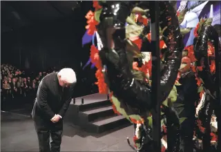  ?? Ronen Zvulun / Associated Press ?? German President Frank-Walter Steinmeier takes part in a wreath-laying ceremony at the World Holocaust Forum in Jerusalem on Thursday.