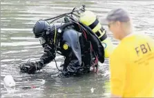  ?? Luis Sinco Los Angeles Times ?? FBI DIVERS search Seccombe Lake for the hard drive from Farook’s home computer. Officials think it may have gone to a landfill.