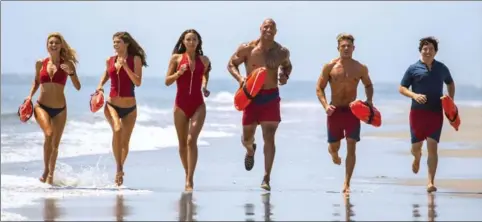  ?? FRANK MASI, PARAMOUNT PICTURES ?? From left, Kelly Rohrbach as CJ Parker, Alexandra Daddario as Summer, Ilfenesh Hadera as Stephanie Holden, Dwayne Johnson as Mitch Buchannon, Zac Efron as Matt Brody and Jon Bass as Ronnie in the film, “Baywatch.”