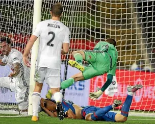  ?? PHOTO: GETTY IMAGES ?? Phoenix goalkeeper Keegan Smith collides with Newcastle Jets attacker Joseph Champness.