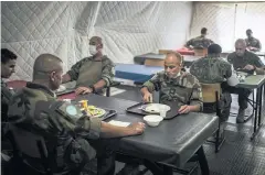  ??  ?? Jean-Jacques, a Muslim chaplain, eats alongside other soldiers on a French army base in southern Lebanon.